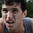 A teen drenched in sweat from playing sports outside. 