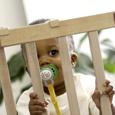 Toddler behind gate to keep her away from poisoning dangers