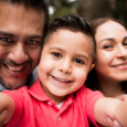 All smiles as a family of three takes a selfie together. 