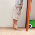 child reaching up on to a table on tip-toes