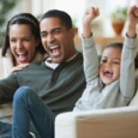 Family enjoys watching the Super Bowl on a properly secured TV Chinese volunteer teaches kids about walking safe