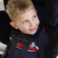 5 Basic Car Seat Rules A smiling child buckled into his car seat.