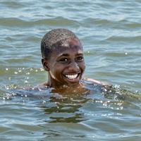 A smiling teen going for a swim.