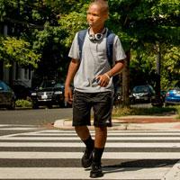 A teen crossing the street.