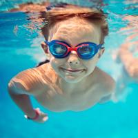 A takes a swim under water while wearing his goggles. 