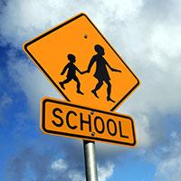 Stop Speeding in School Zones A school zone sign.