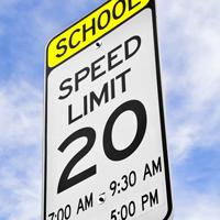 Calming traffic around schools zones A school speed limit traffic sign.