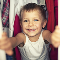 Remembering Gun Safety in the Time of COVID-19 A young boy looking through his closet.