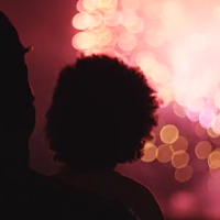 parent and child watch fireworks display from a distance parent and child watch fireworks display from a distance