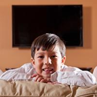 Keeping Kids Safe When Moving to a New Home A young boy smiles in his new home.
