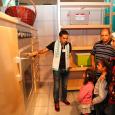 Safe Kids staff demonstrates an oversize model kitchen