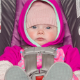 baby in rear-facing car seat with coat