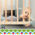 A baby pulling on a safety gate.