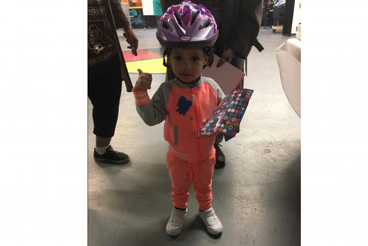 Cute little kid with his bike helmet at the GM Detroit Checkup Event