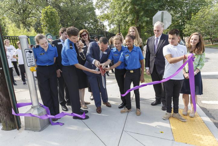 staff, students, and admin of Atlanta Public School cutting the ribbon on their Safe School Zone