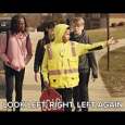 kids being directed by a crossing guard before they cross the street